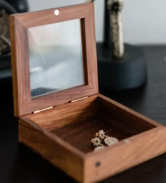 Dark wood gift box with glass lid.